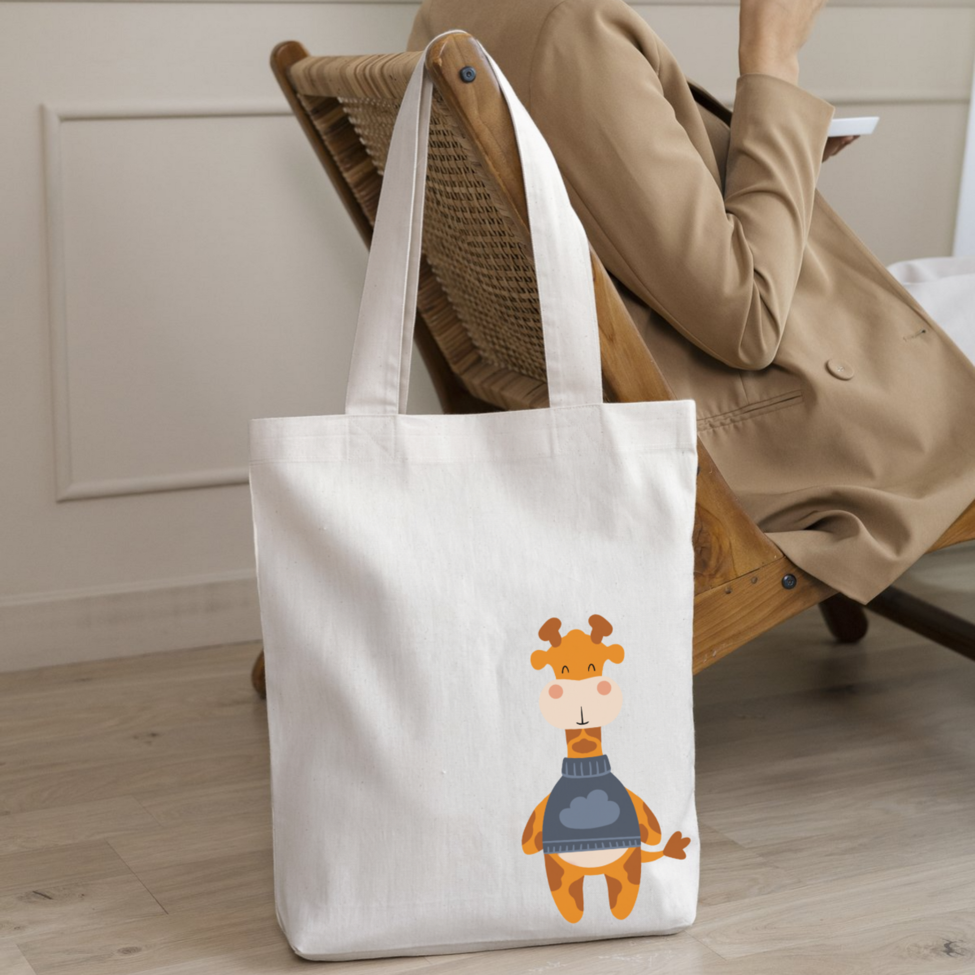 Mujer con saco con la bolsa tote bag de la marca de ropa nube con estampado de la jirafa Lázaro colgada en el respaldo del sillón.