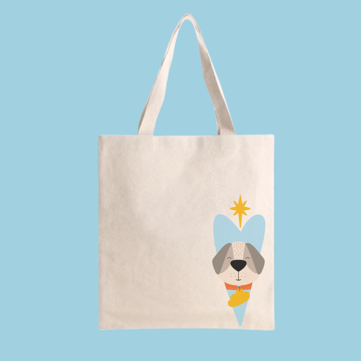 Bolsa Tote Bag color beige con estampado del diseño del perro Leandro con collar naranja y placa amarilla de la marca de ropa nube dentro de un corazón azul. Arriba lo guía una estrella amarilla.